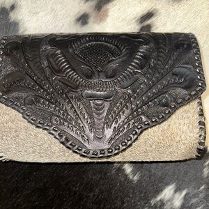 Hand-tooled leather Crossbody bag. 
Artisan Black leather and Cowhide Clutch